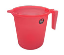 Red plastic mug with a handle on a gray surface, blurred background of shelves.