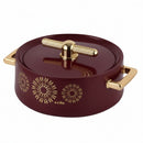 Black and gold kitchen lid with decorative patterns on a white background