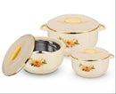 Set of three cream-colored cookware pieces with floral designs and gold accents on a white background