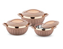 Set of three rose gold ceramic cookware pots on a white background