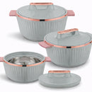 Set of gray cookware with rose gold handles and trim on a white background