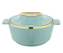 green cookware with gold rim on a white background