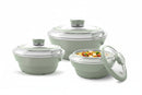 Set of three green cookware items with lids on a white background