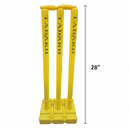 Three yellow plastic cricket wickets with 'TABAKH' printed vertically on each, standing on a matching base, shown with a 28-inch height measurement marker on a white background.