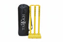Yellow plastic cricket wickets with 'TABAKH' printed vertically, shown next to a black carrying bag with the same branding.