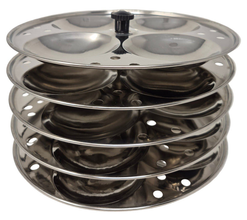 Stack of metal trays with circular holes on a white background