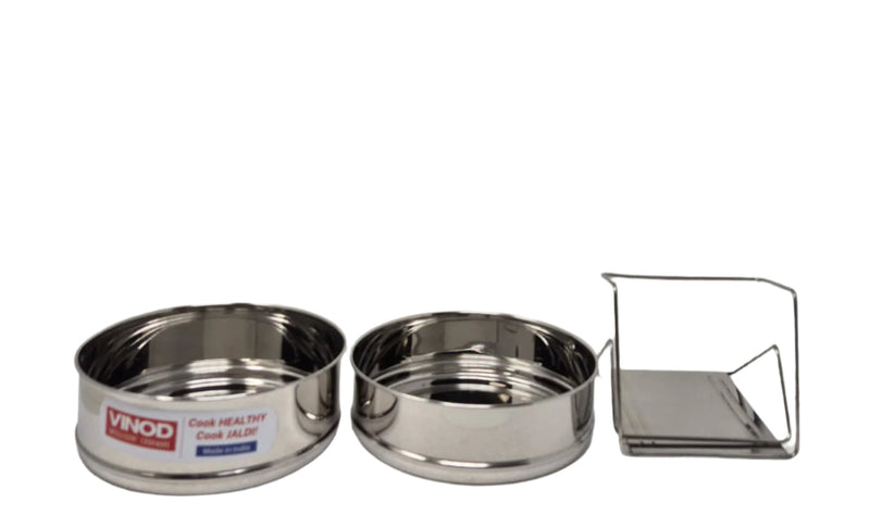 Set of stainless steel containers with a lid on a white background