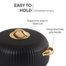 Black cookware with gold lid and handle on a white background