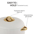 White pot with gold lid and handle on a white background, highlighting ease of holding.