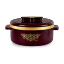 Maroon pot with gold lid and decorative emblem on a white background