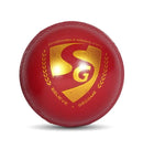 Red cricket ball with a gold logo on a white background